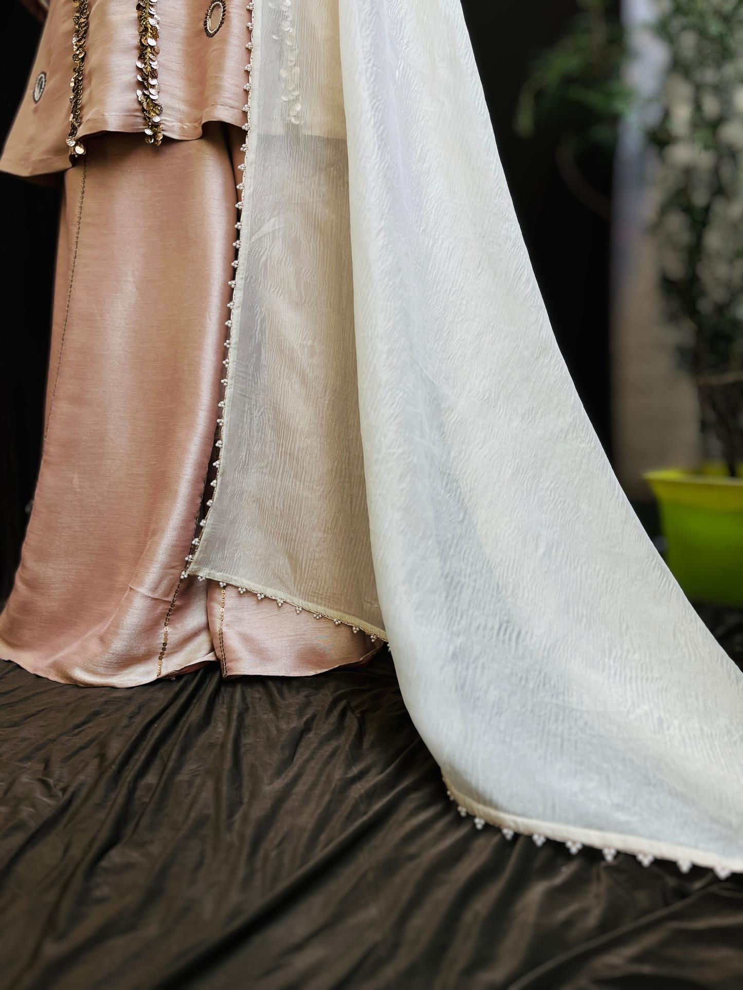 kurta is paired with a graceful sharara and dupatta