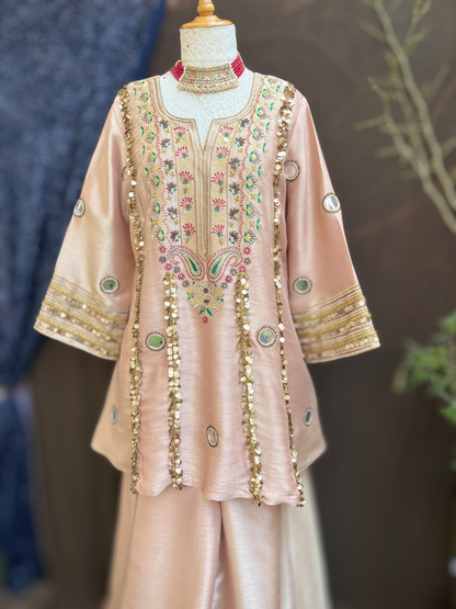 kurta is paired with a graceful sharara and dupatta